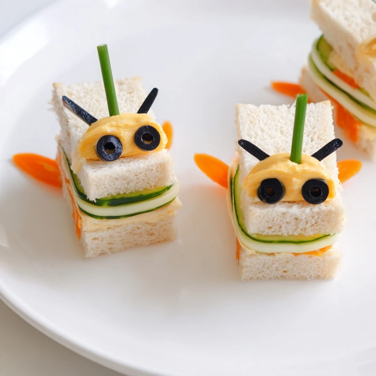 Bee-shaped sandwiches with colorful fruits and veggies, a fun, healthy kids lunch board.