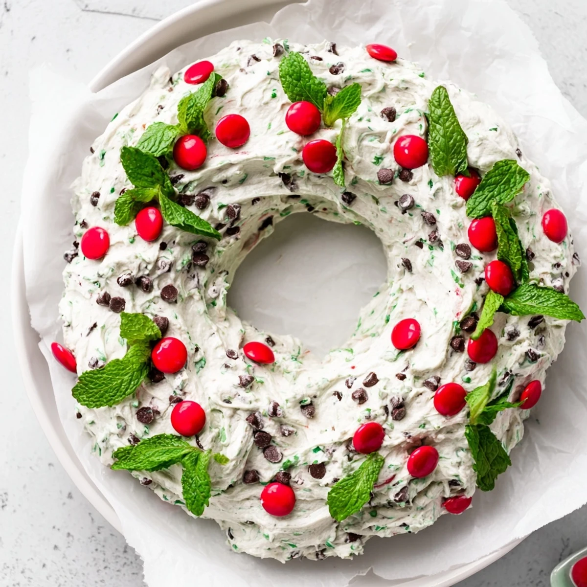 Close-up of a holiday-themed Mint Chocolate Chip Dip Wreath, a delicious dessert dip with fresh mint.