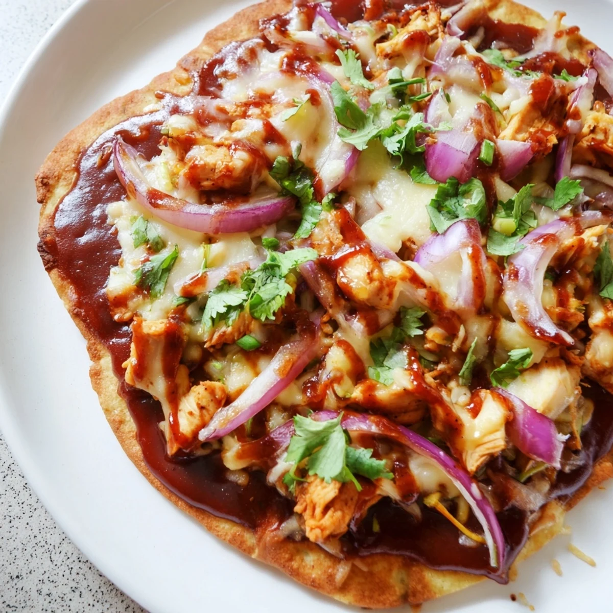 Golden-crusted BBQ Chicken Flatbread, loaded with toppings, is perfect for a quick dinner.