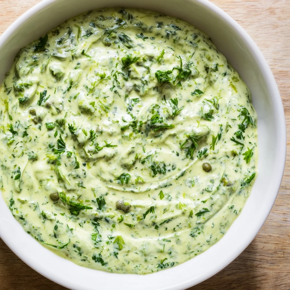 Creamy Green Goddess Dip, a vibrant, fresh dip perfect served alongside crunchy carrots and celery sticks.