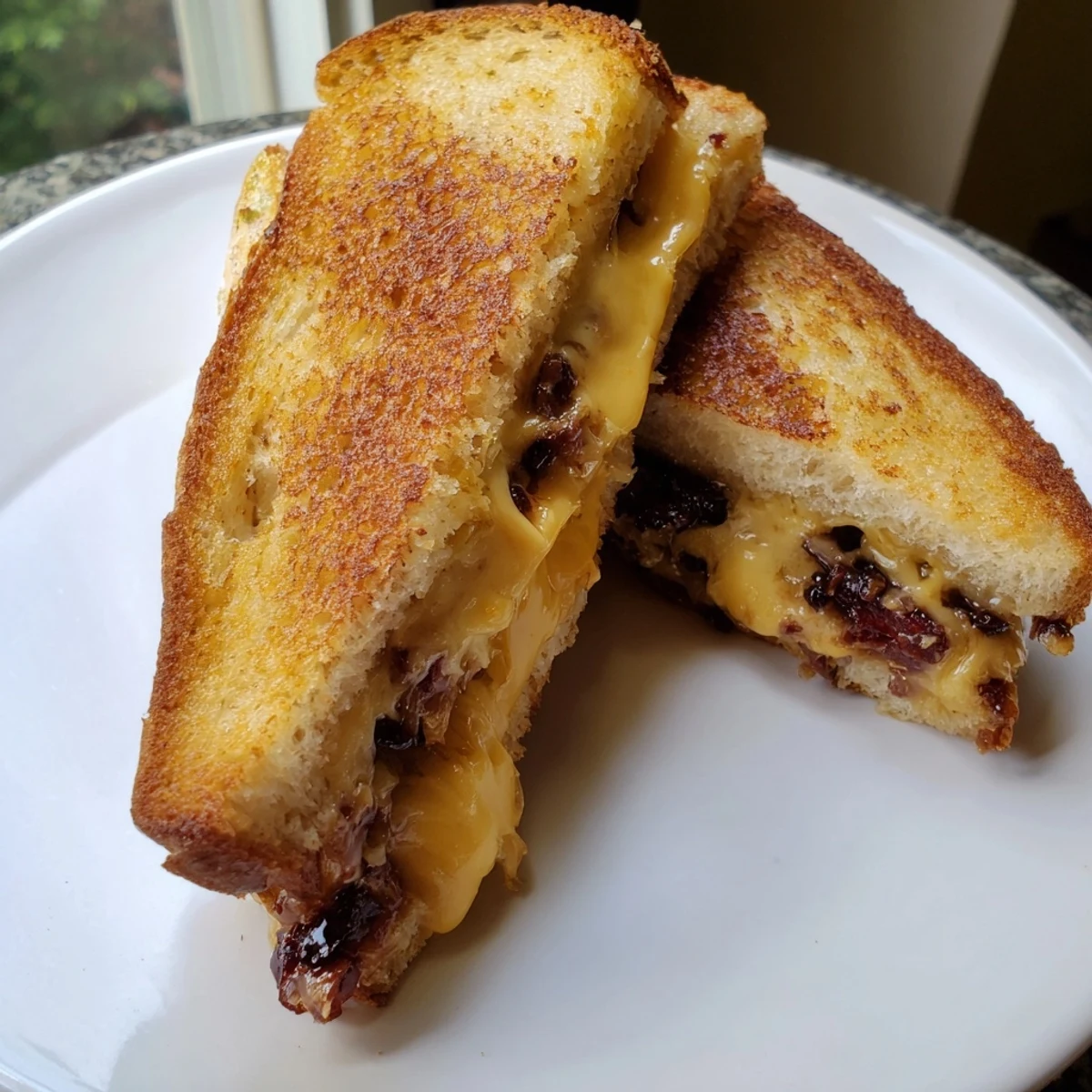 A close-up shot of a perfectly grilled Bacon Jam Grilled Cheese, showcasing crispy bread and gooey cheese.
