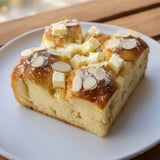 Close-up of a delightful German Butter Cake, highlighting the rich butter and sugared almond crumble.