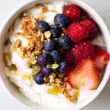Fresh berries and crunchy granola top a cottage cheese hot honey bowl, a delightful snack or breakfast.