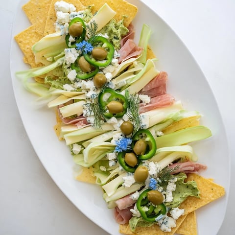 A visually stunning Deep Sea Ocean Wave appetizer platter overflowing with vibrant green veggies.