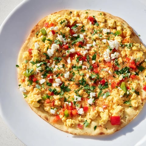 Turkish Menemen Eggs Pizza topped with creamy feta cheese, ready to slice and enjoy.