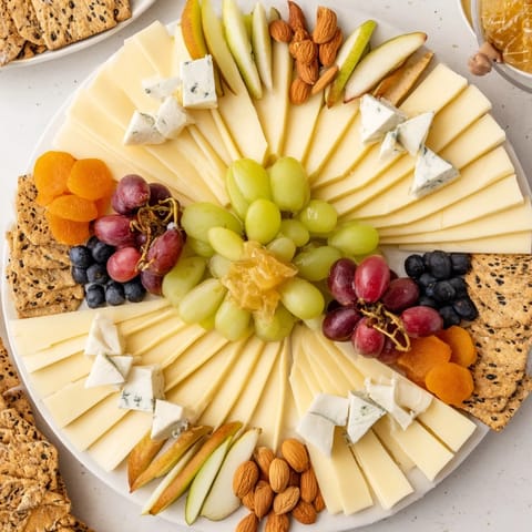 Elegant Art Deco Arch Cheese Platter features arranged cheeses, fruits, and crackers perfect for serving.