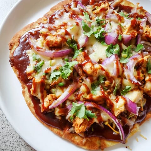 Golden-crusted BBQ Chicken Flatbread, loaded with toppings, is perfect for a quick dinner.
