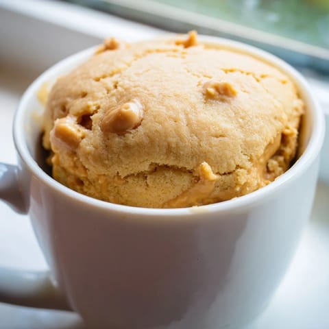 Enjoy a single-serve 2-Minute Peanut Butter Mug Cake, a quick American dessert delight.