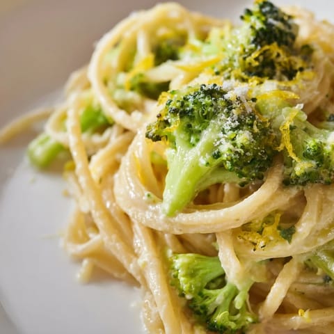 One-Pot Lemon Broccoli Pasta with vibrant green florets coated in a silky garlic sauce and grated Parmesan garnish, served steaming in a rustic bowl.